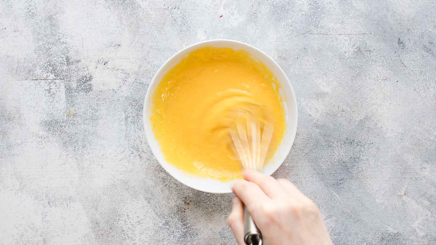 whisking egg yolks and cornstarch in a small bowl