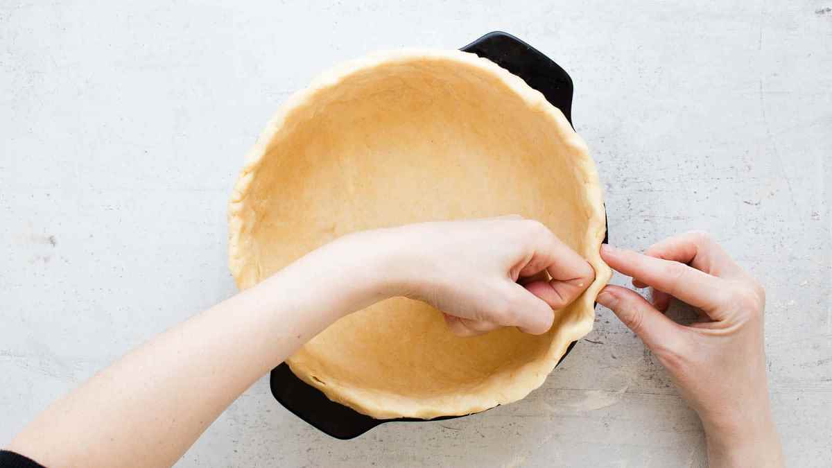 Pressing the crust into a baking pan