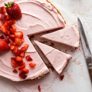 Cheesecake sliced into pieces and garnished with strawberries