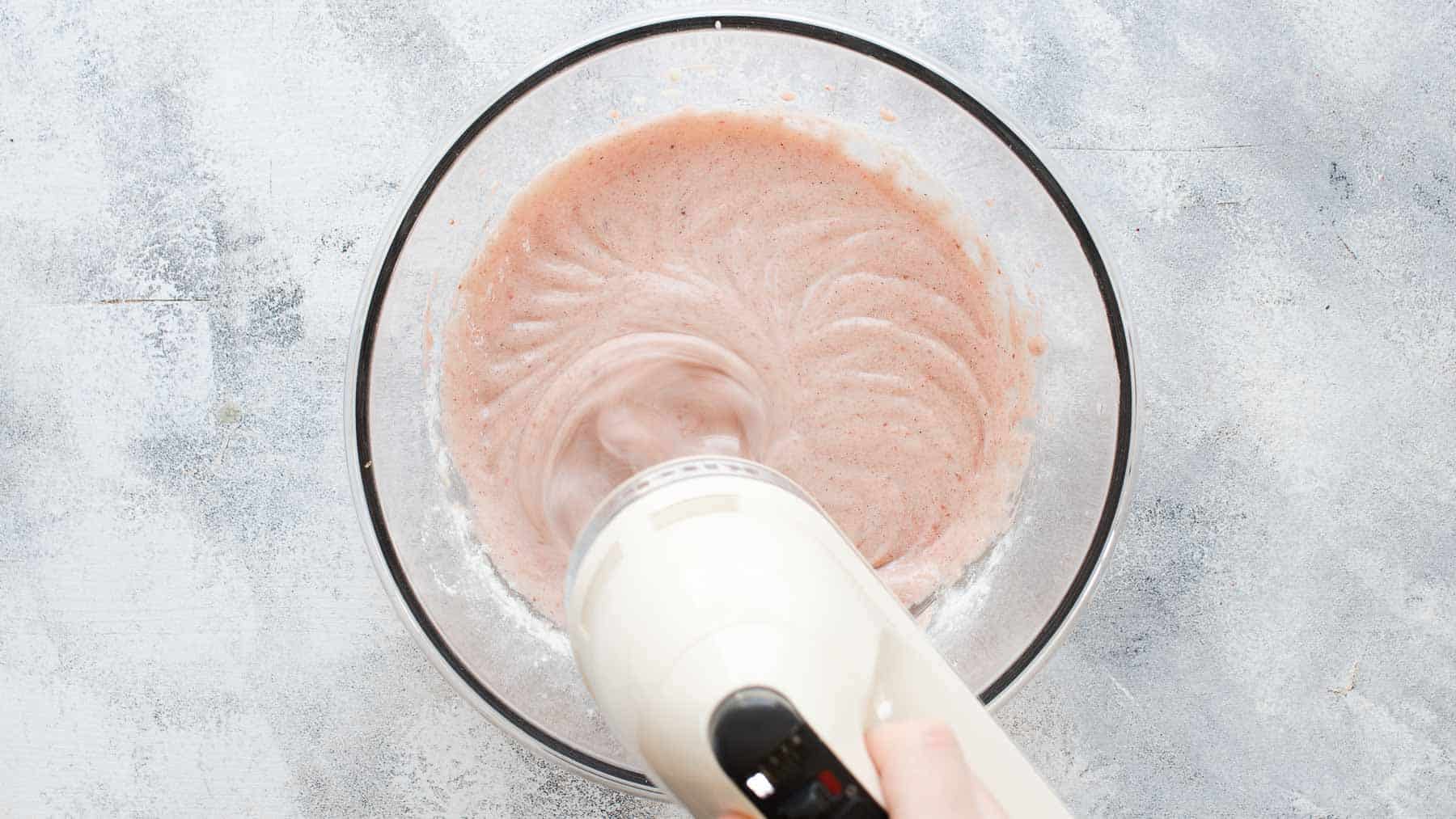 Mixed strawberry batter in mixing bowl