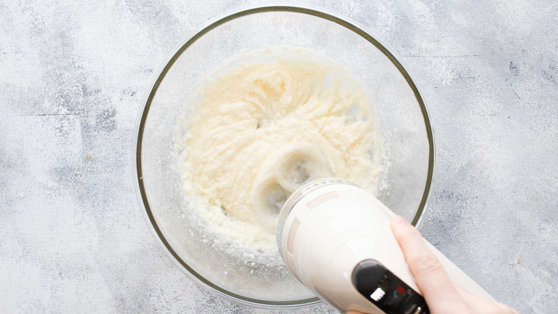 mixing oil, butter, and sugar in mixing bowl