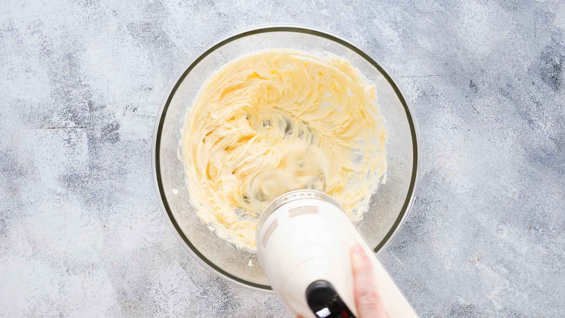 whipping up frosting for blackberry cake