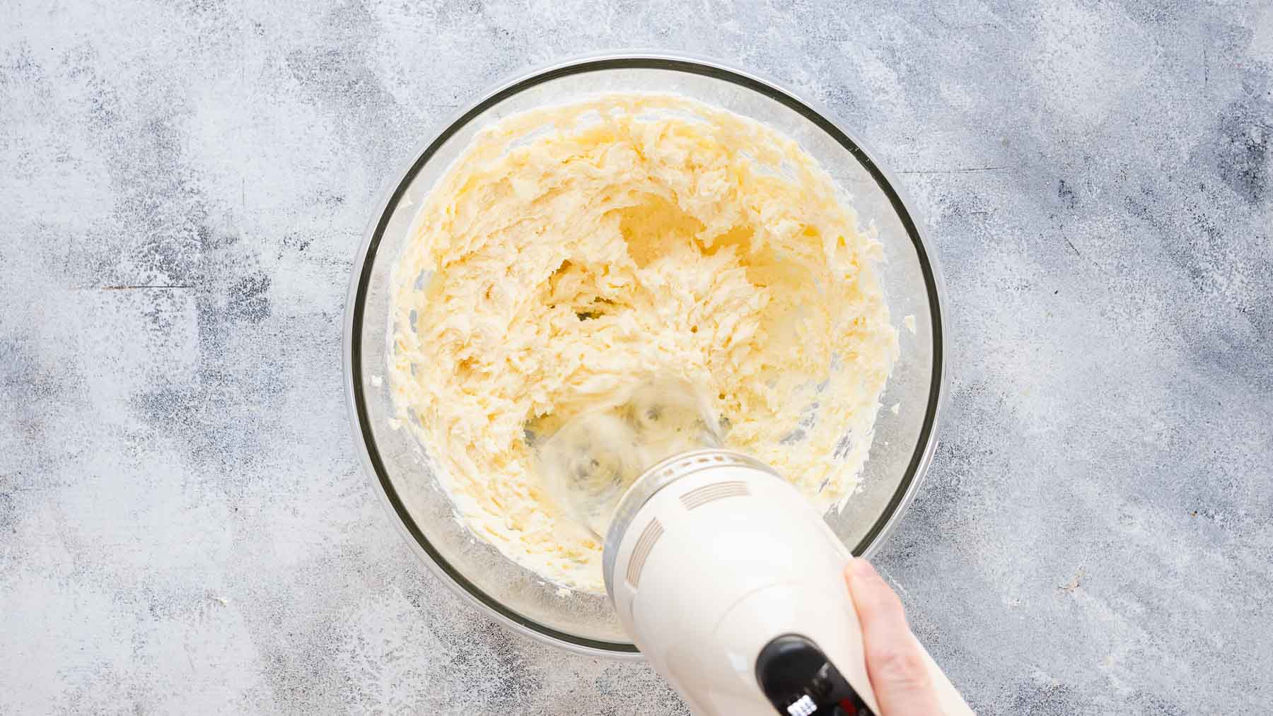 mixing cream cheese into whipped butter