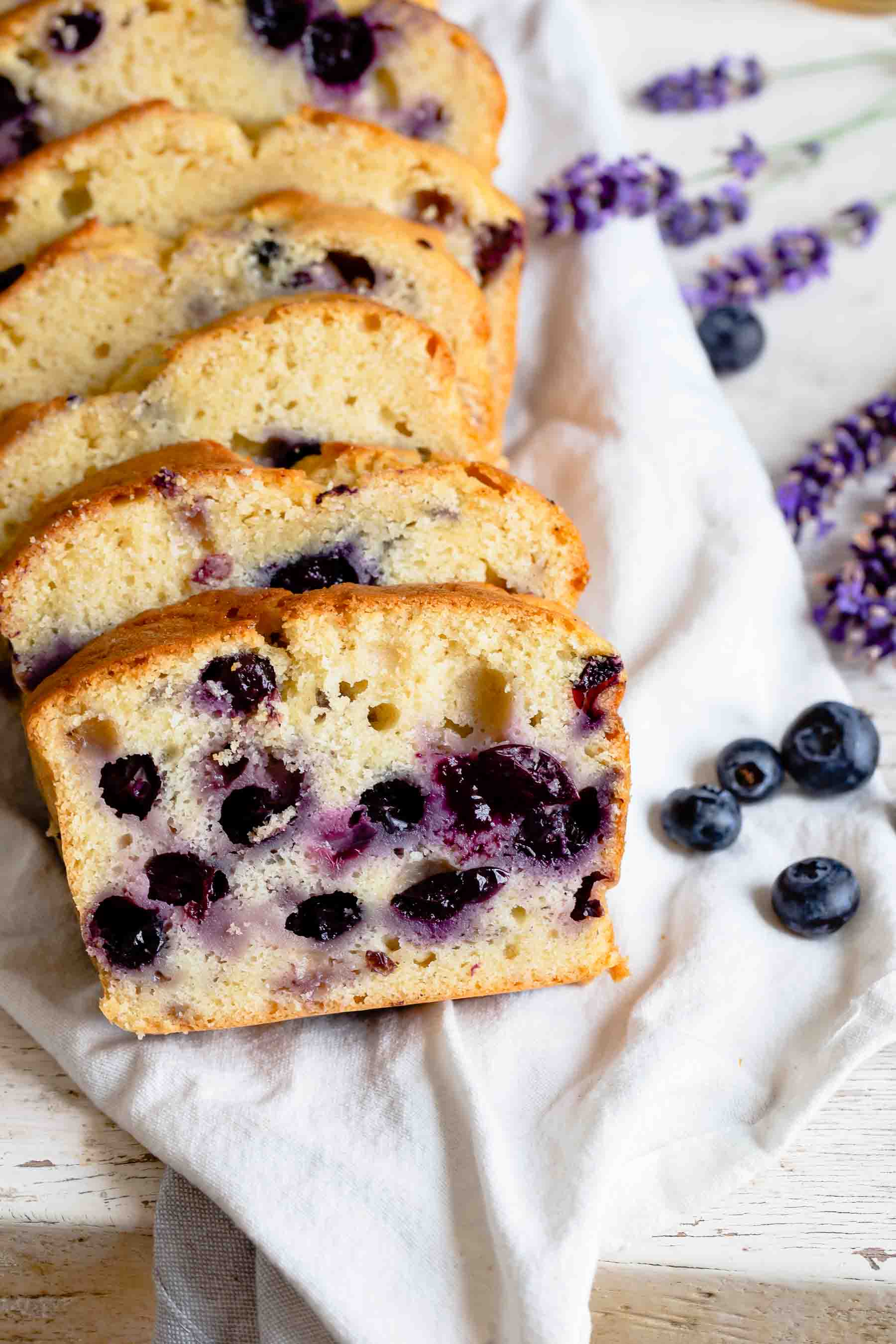 fresh blueberry bread sliced and placed on top of a towel