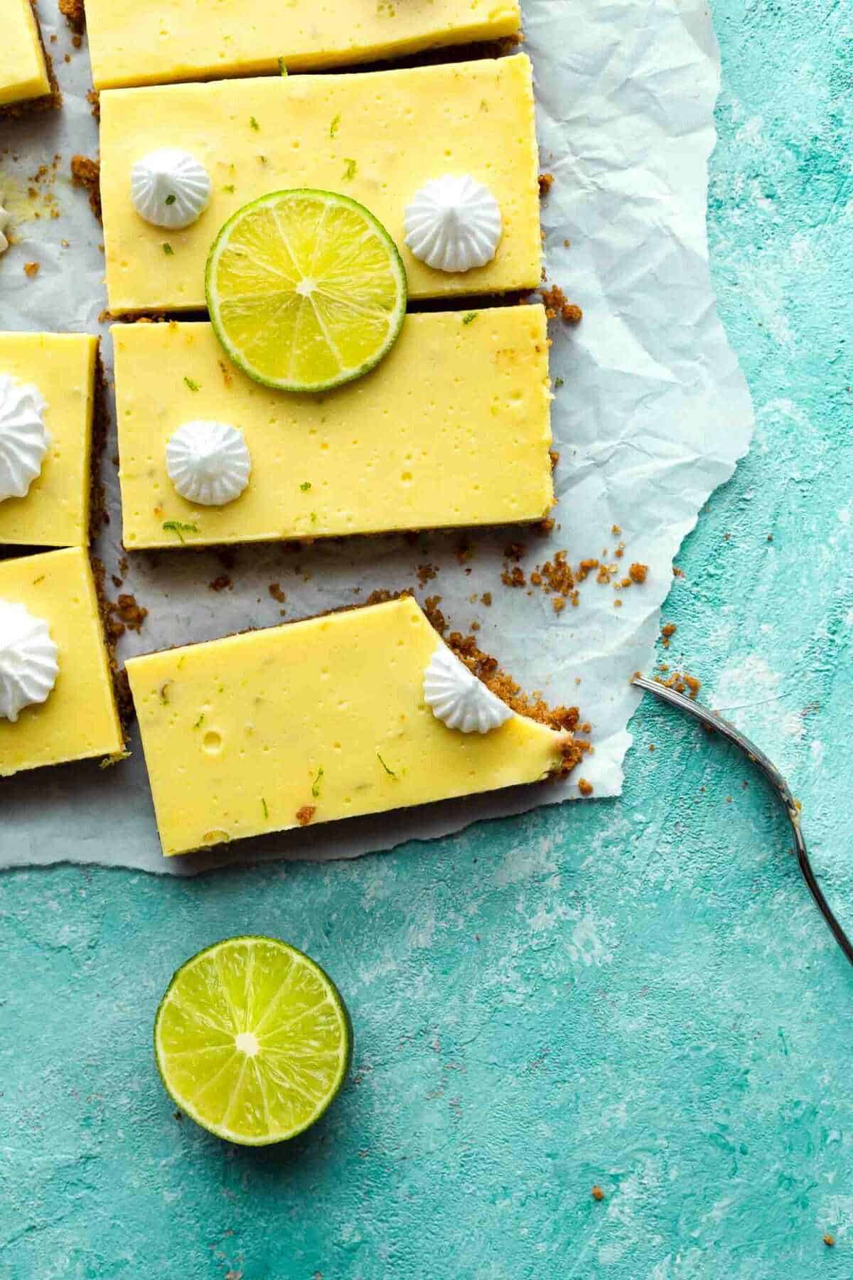 key lime bars with a bite taken out on counter