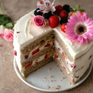 Decorated strawberry cake with a slice cut out
