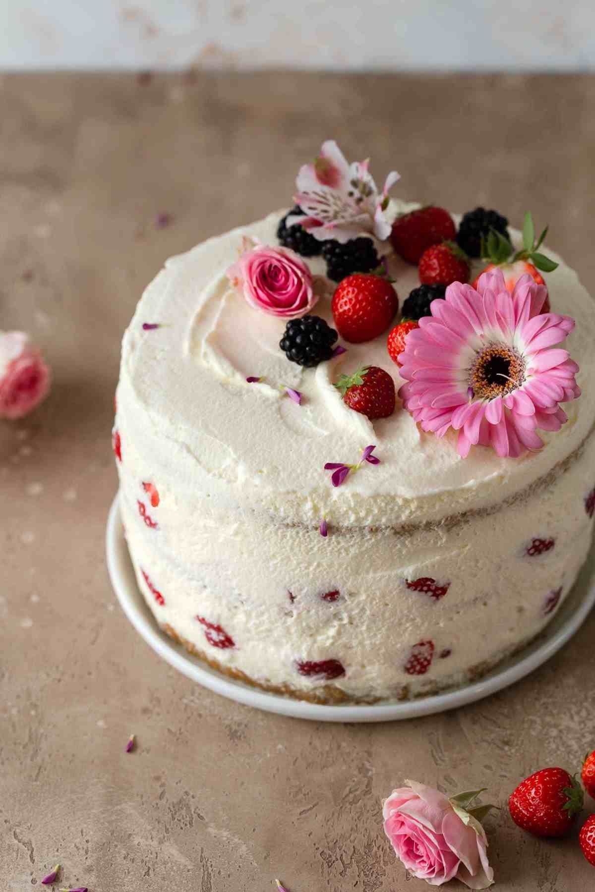frosted strawberry cake with flowers on top