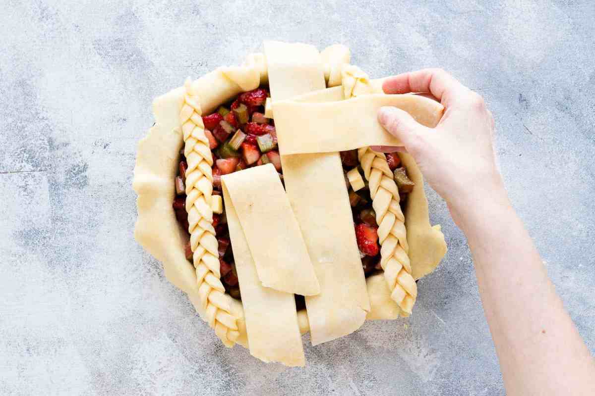 laying pie crust onto pie