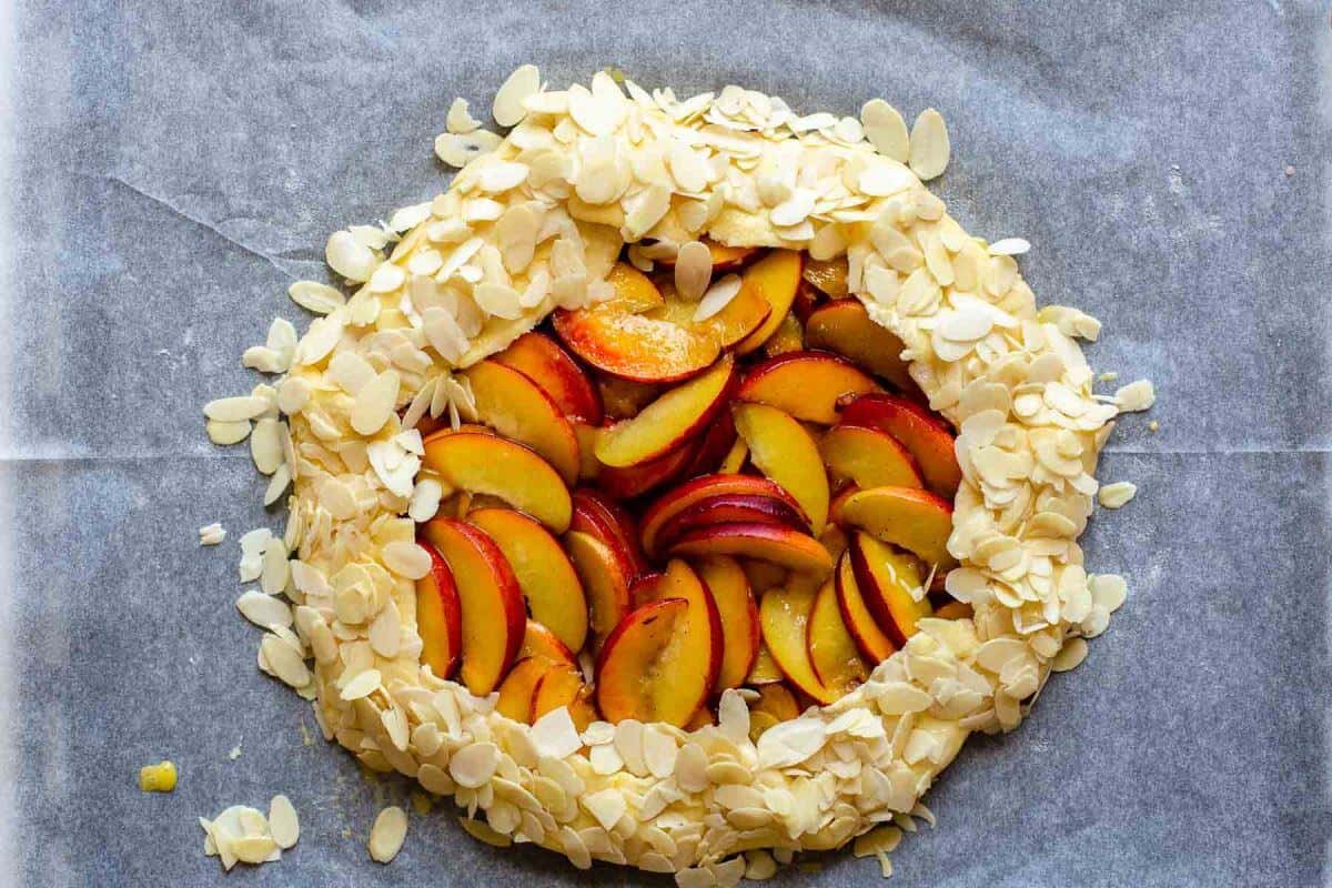 ready to cut almond peach galette on table