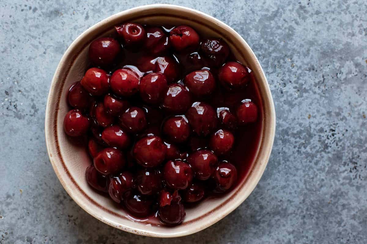 Cherries covered in syrup in a bowl