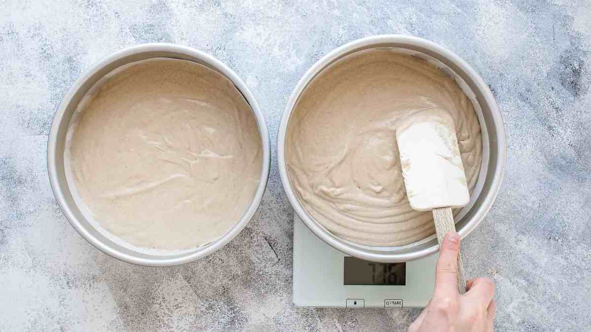 pouring batter into cake pan and measuring