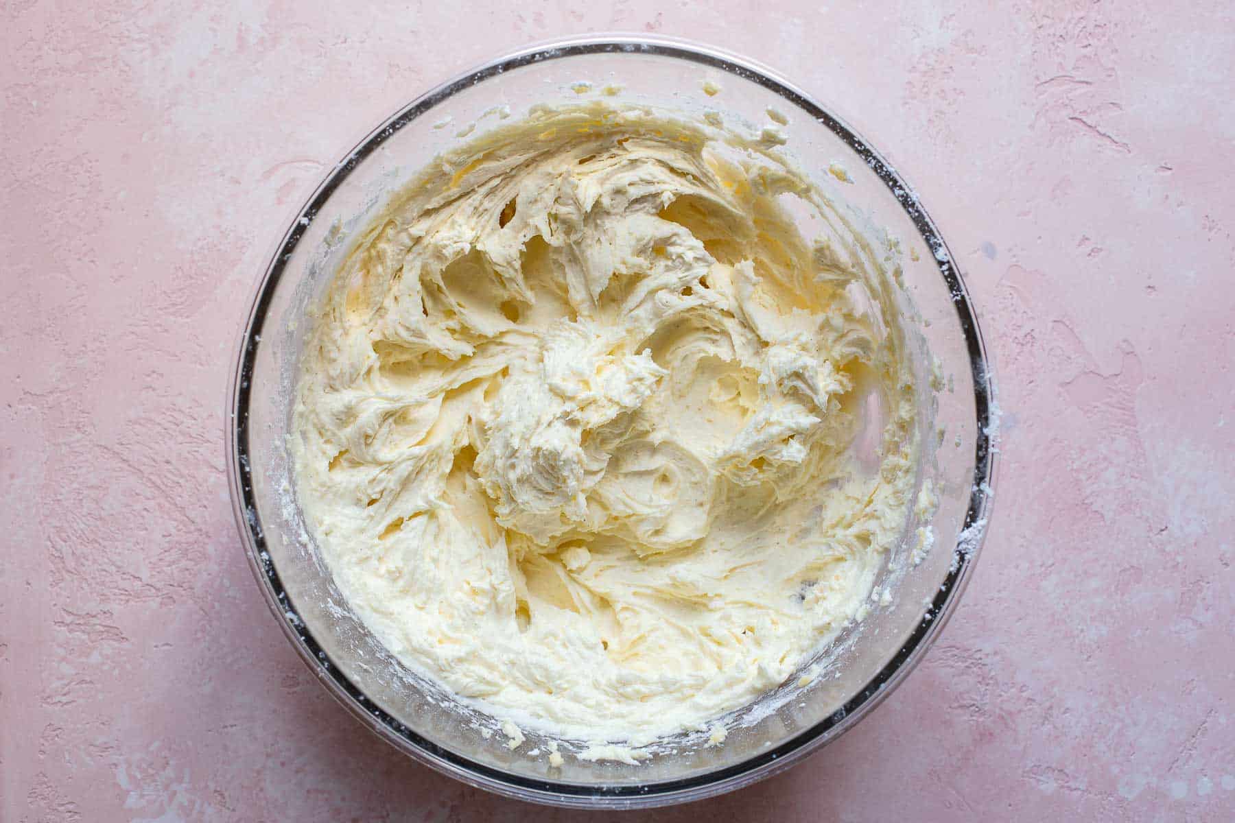 whipped buttercream frosting in a mixing bowl