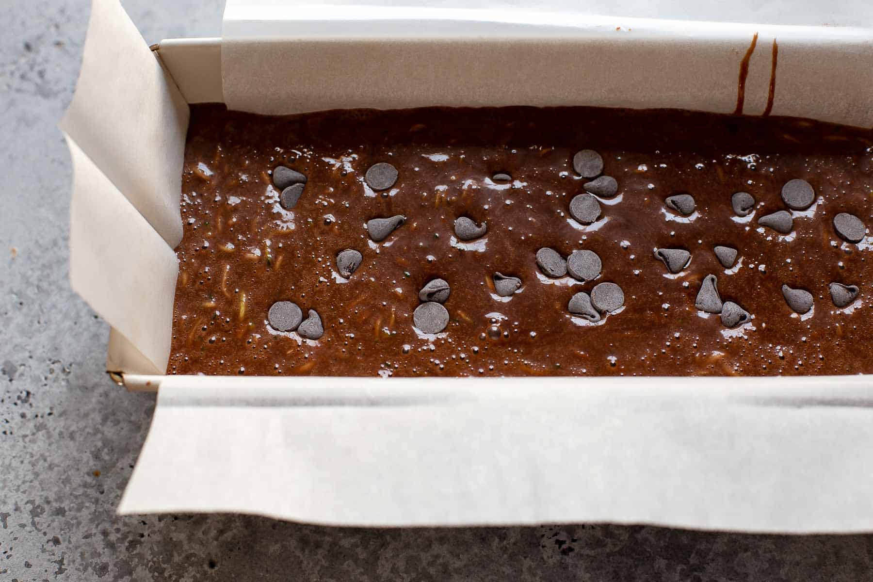 chocolate zucchini cake batter in a loaf pan