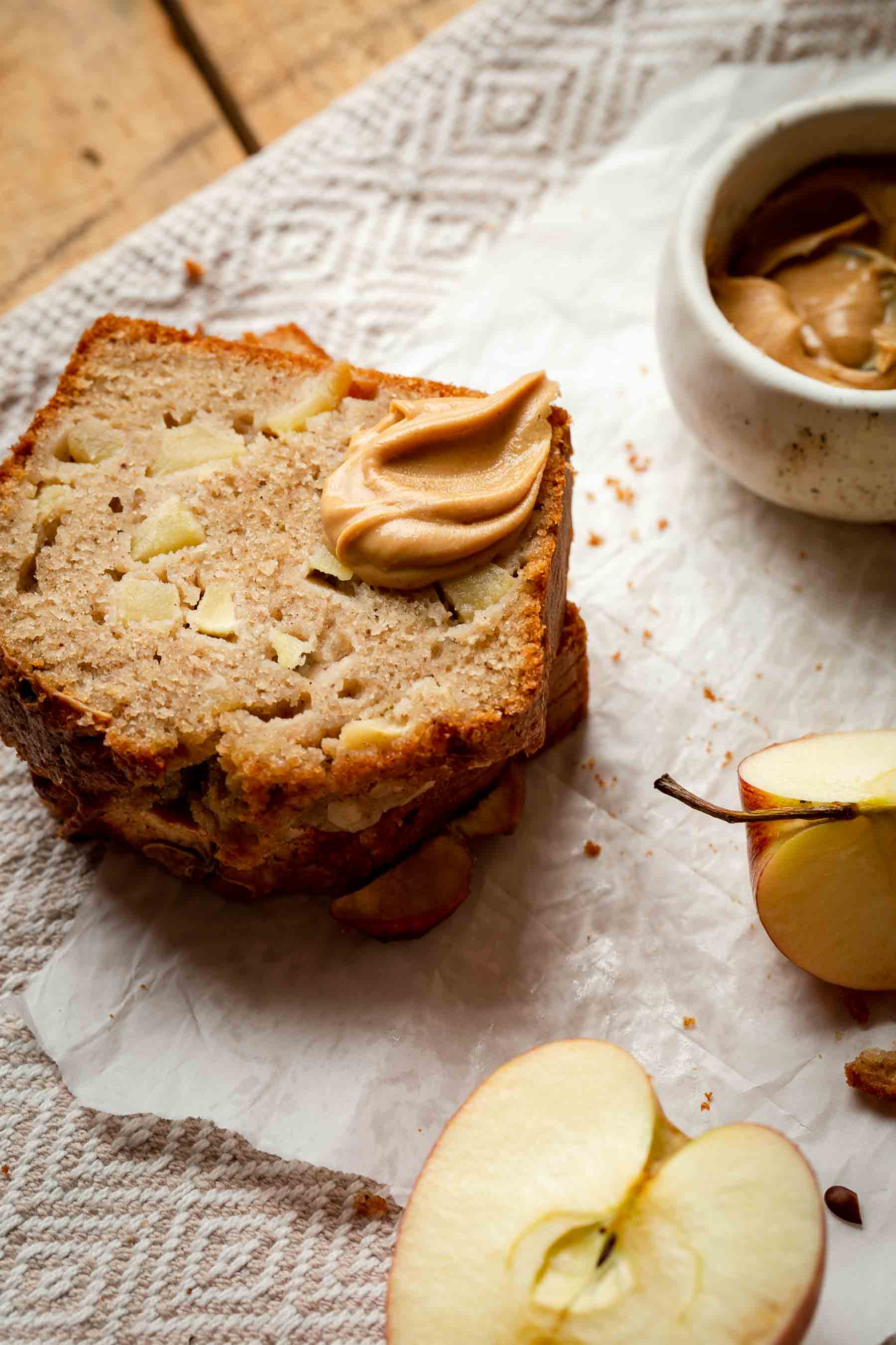 slices of baked apple bread with peanut butter and fresh apples 