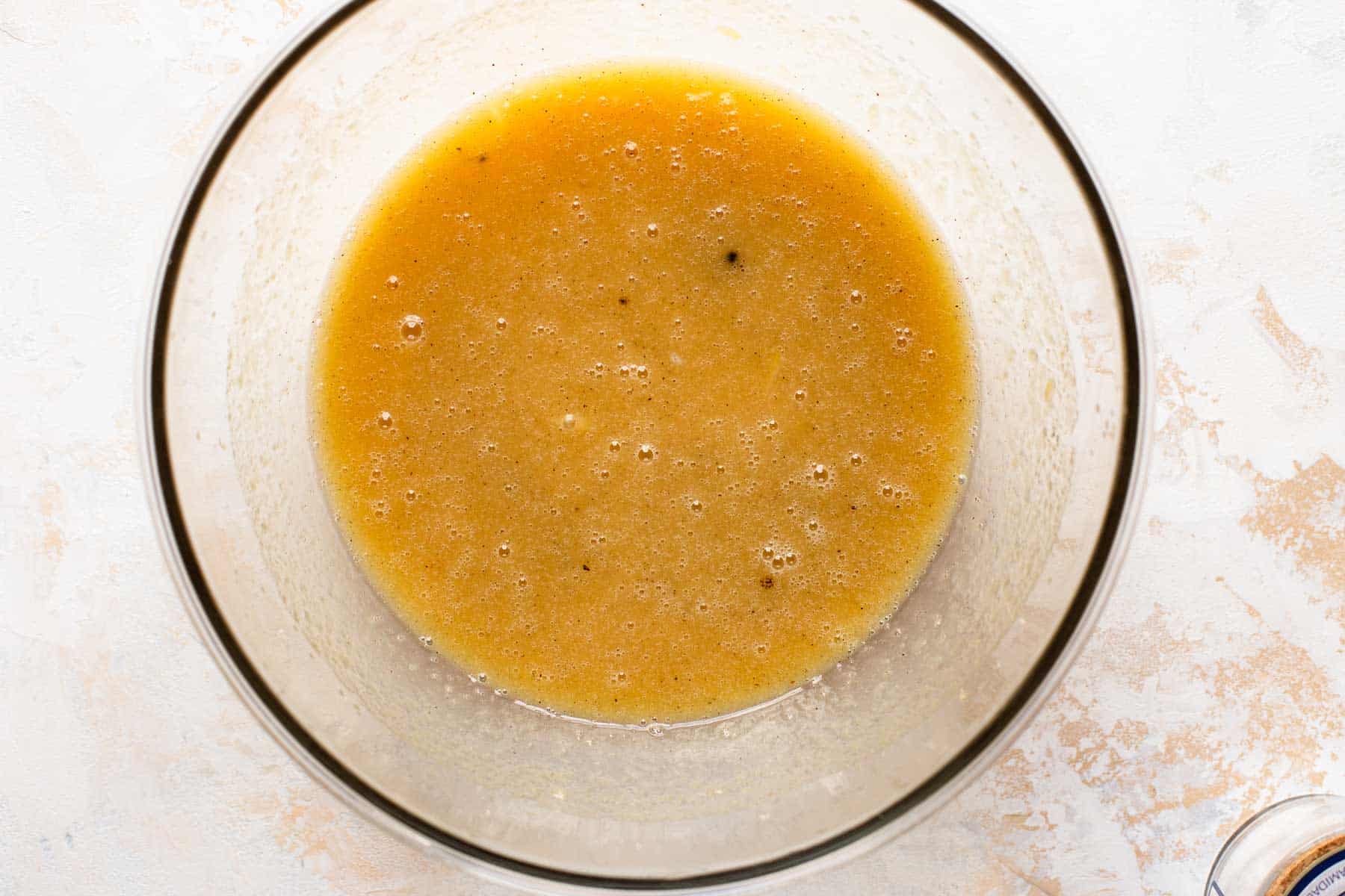 egg, applesauce, vanilla, and sugar mixed together in a bowl