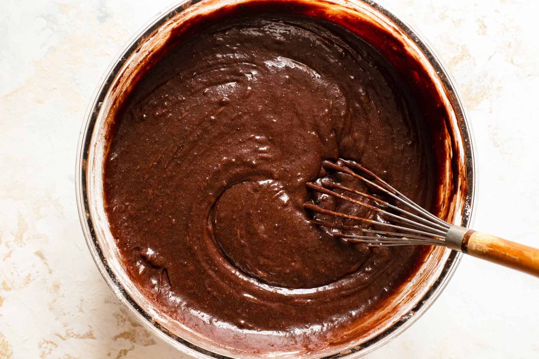 brownie batter in a bowl with a whisk