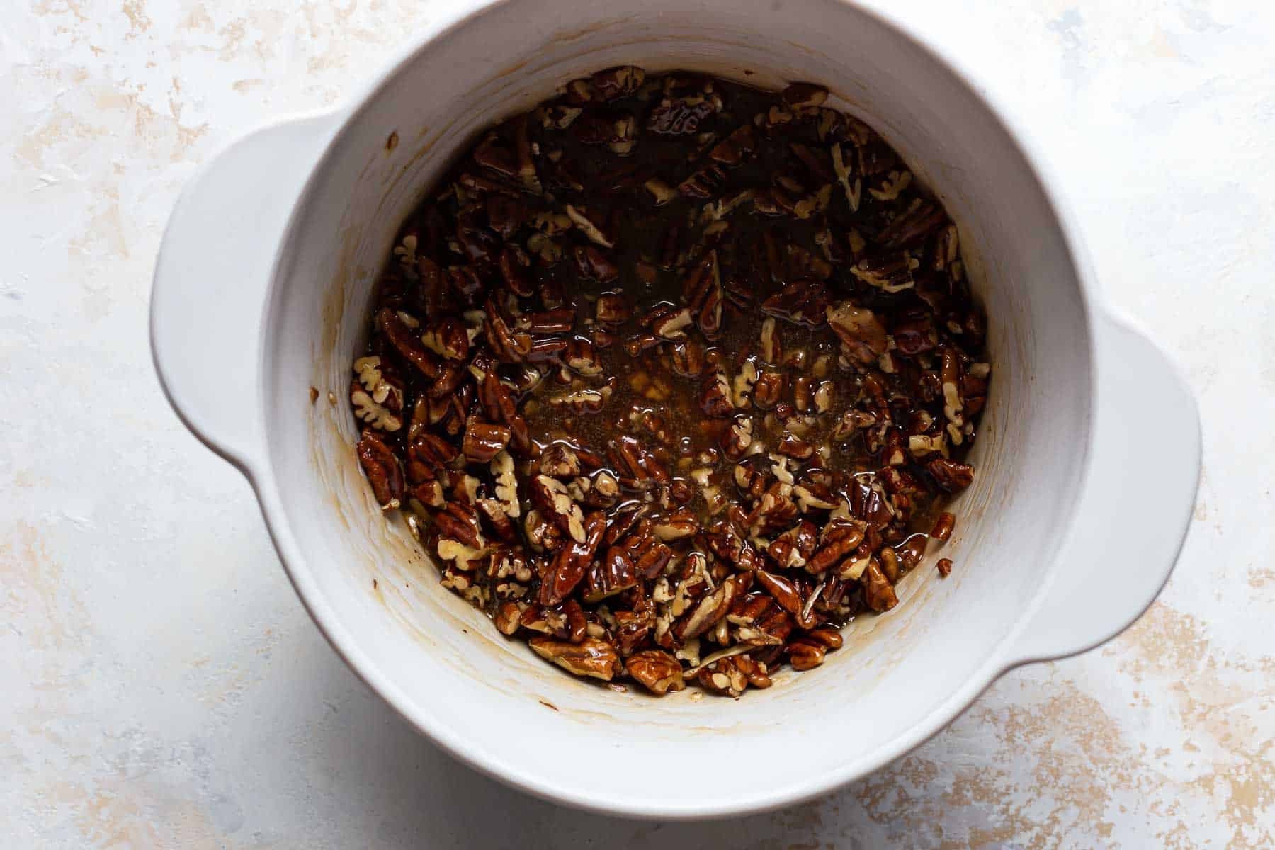 cooked pecan honey filling in a white pot