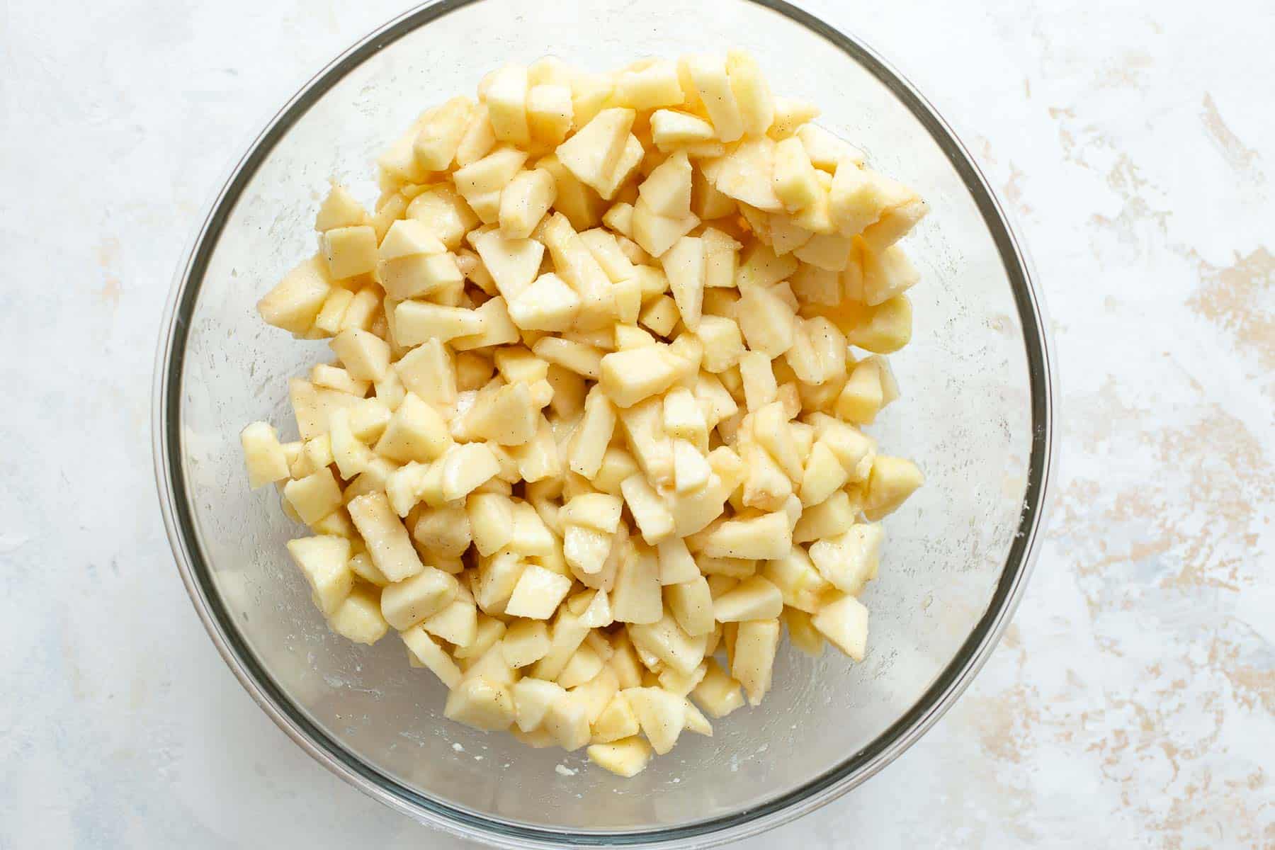 diced apples in glass bowl