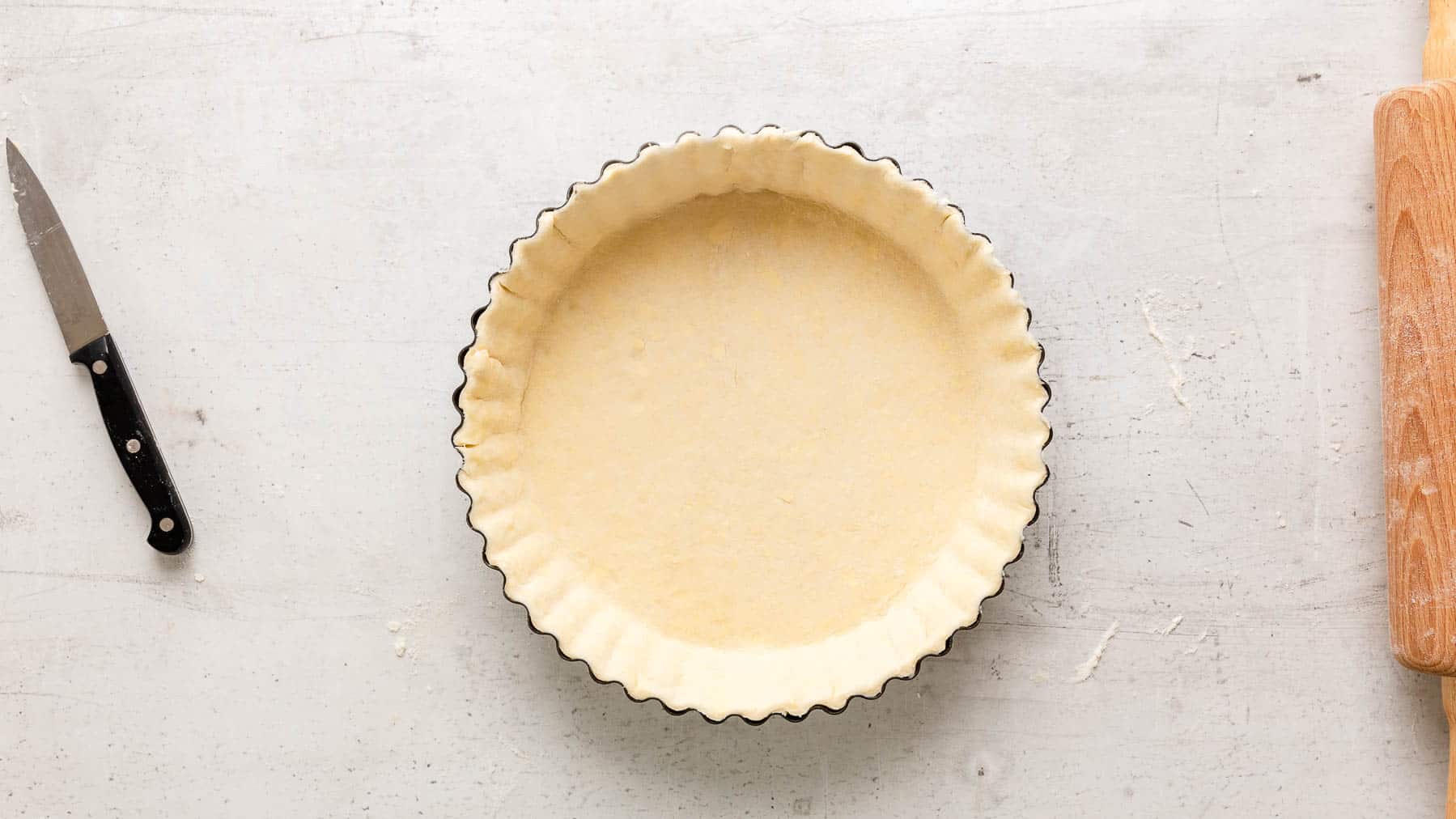 raw pie crust in a pie dish