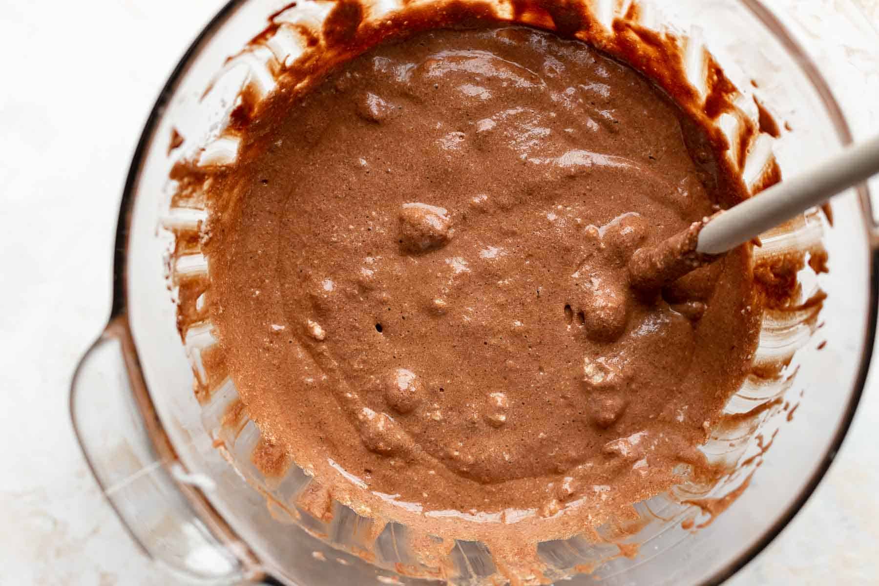 mixing chocolate batter with a wooden spoon