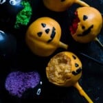 Decorated cake pops on black background some of them half eaten