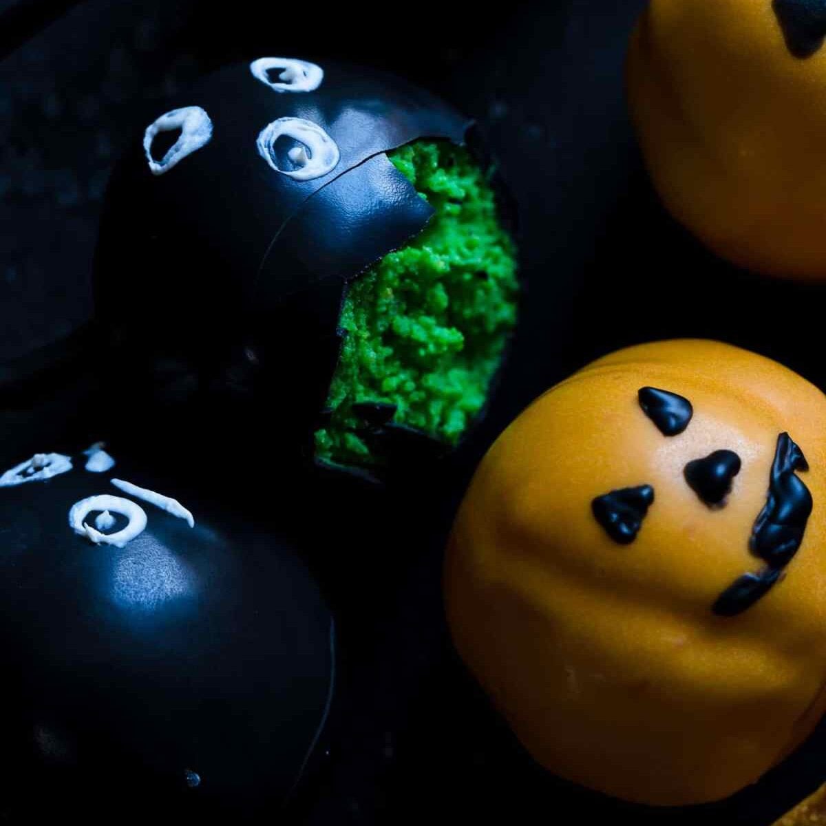 bitten halloween cake pops on black surface