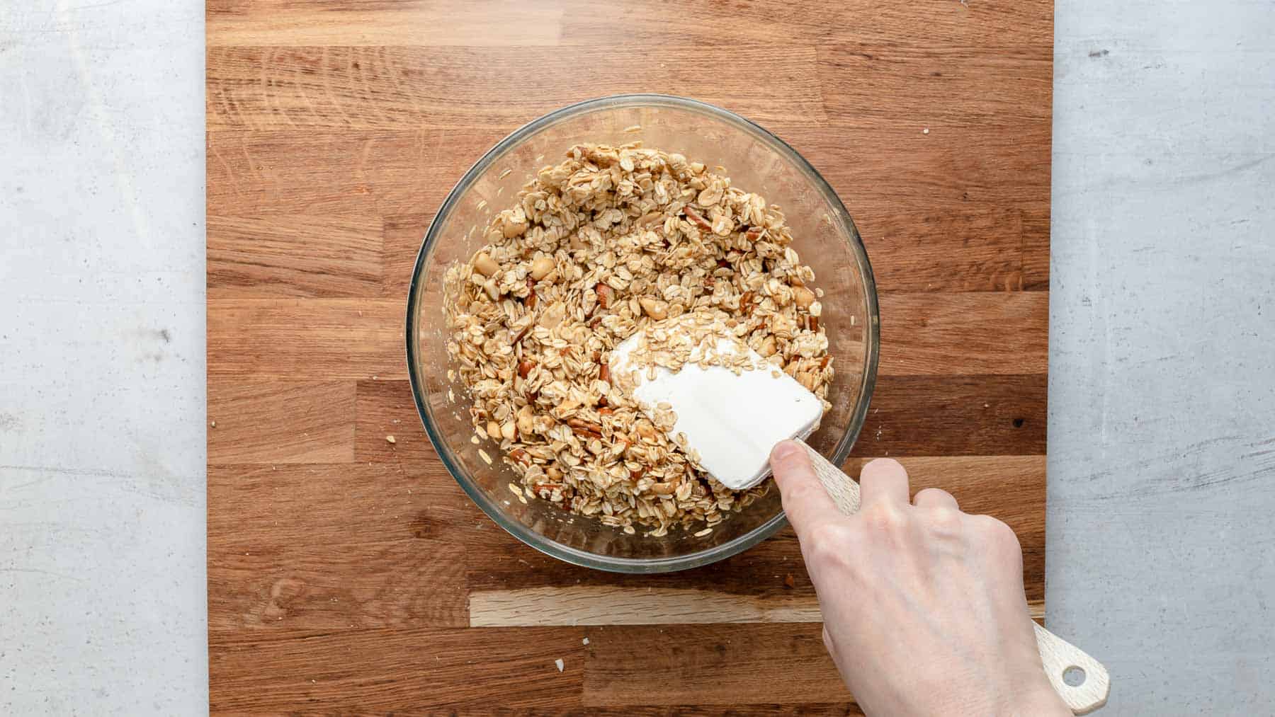 mixing nuts in bowl with a spatula