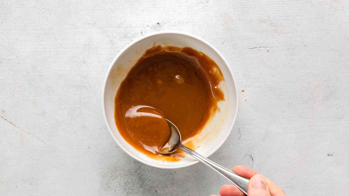 caramel sauce in a bowl with spoon