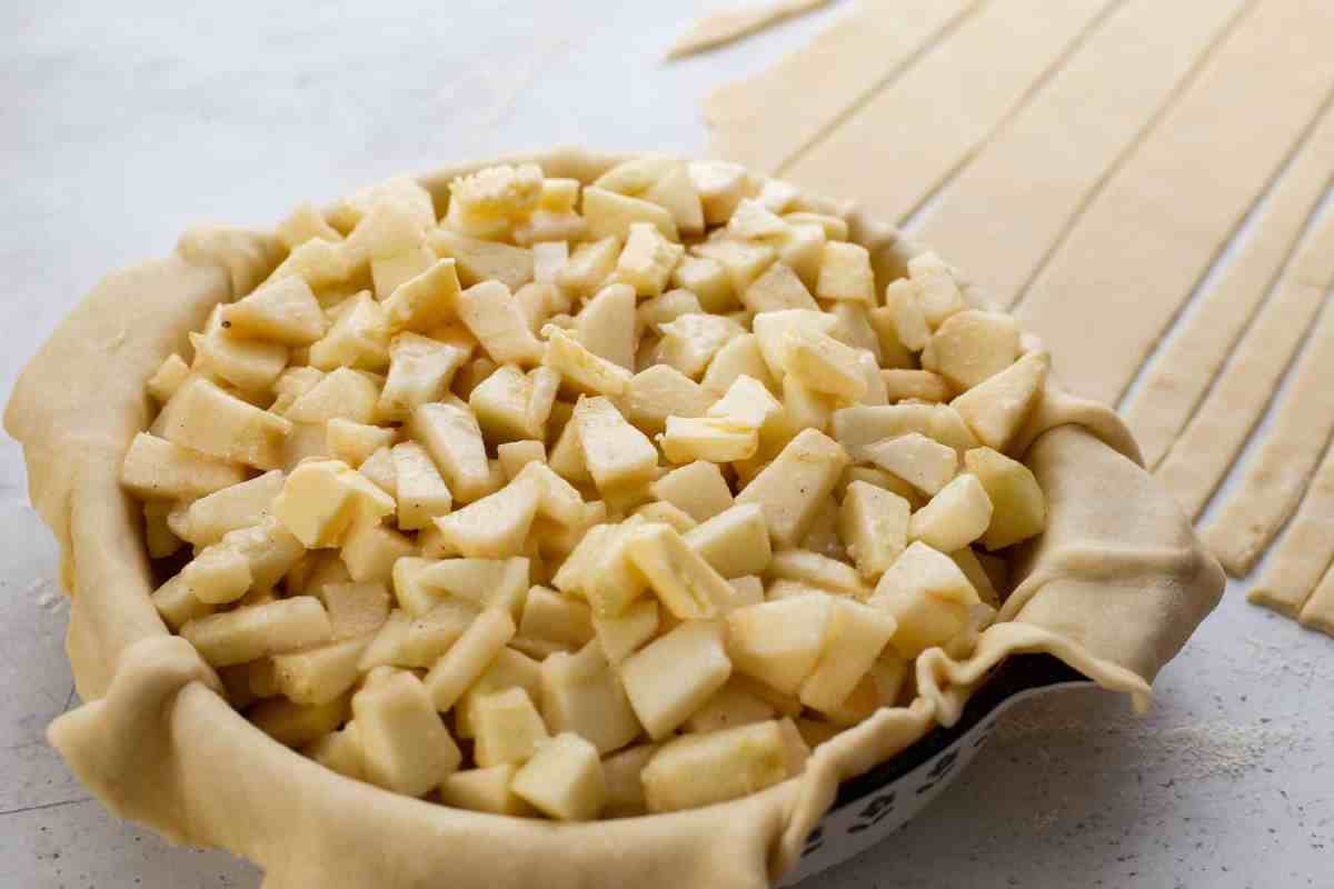 diced up apples in pie crust