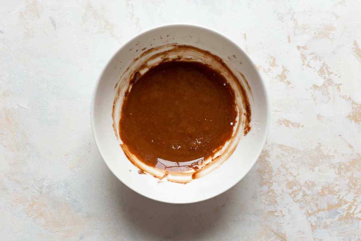 egg yolks, cornstarch, and cocoa powder in white bowl mixed together