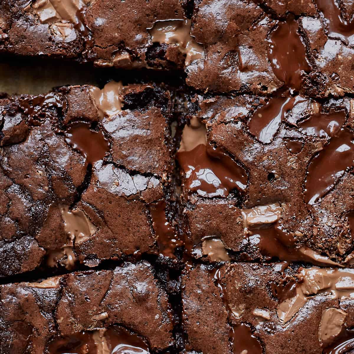 Close up of crispy brownie tops with pockets of melted chocolates