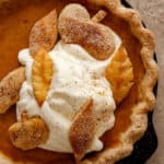 Decorative close-up picture of pumpkin pie on brown background