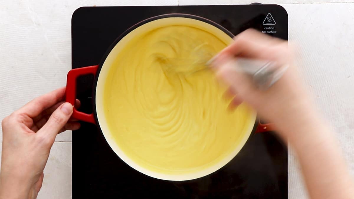Cooking the banana pudding filling while whisking