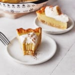 Decorative picture of a bitten banana cream pie slice on a white plate