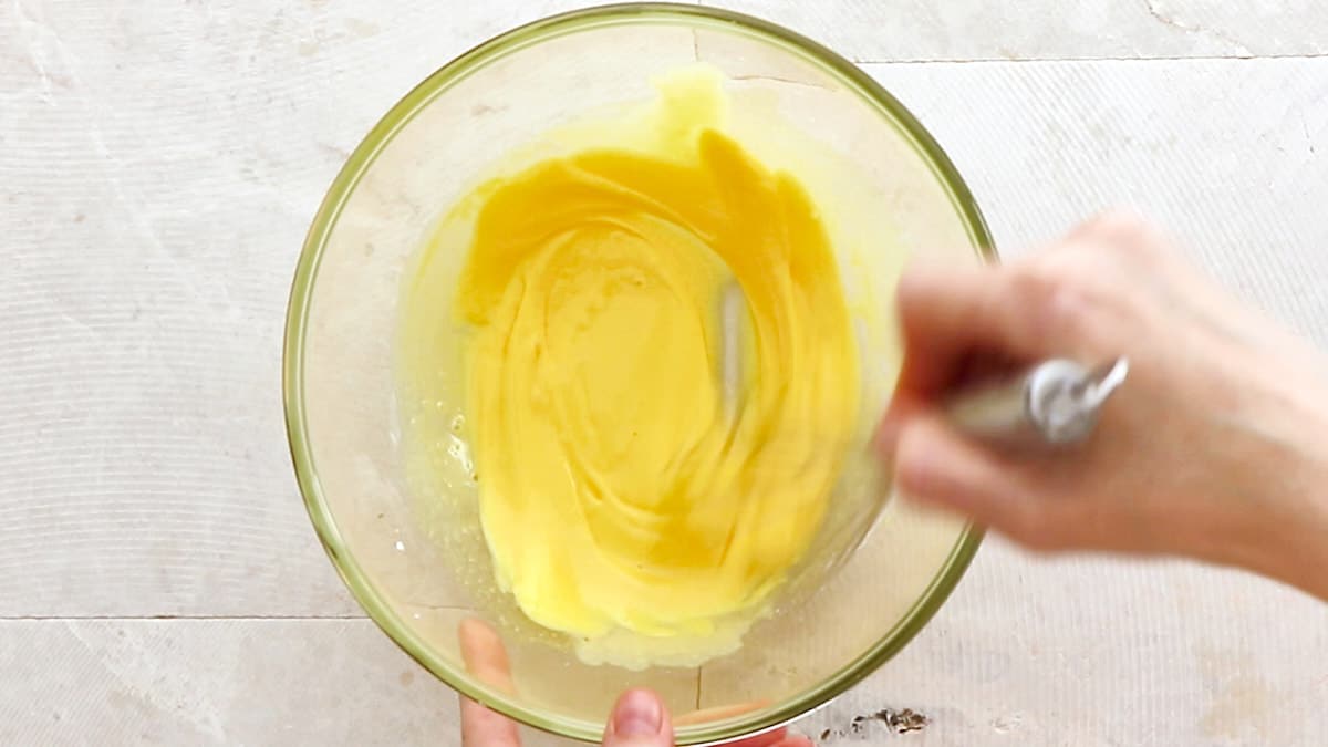 Whisking egg yolks, sugar, and cornstarch in a large mixing bowl
