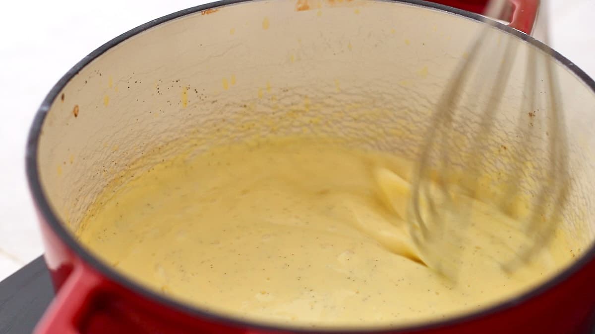 Whisking thickened egg mixture in the saucepan