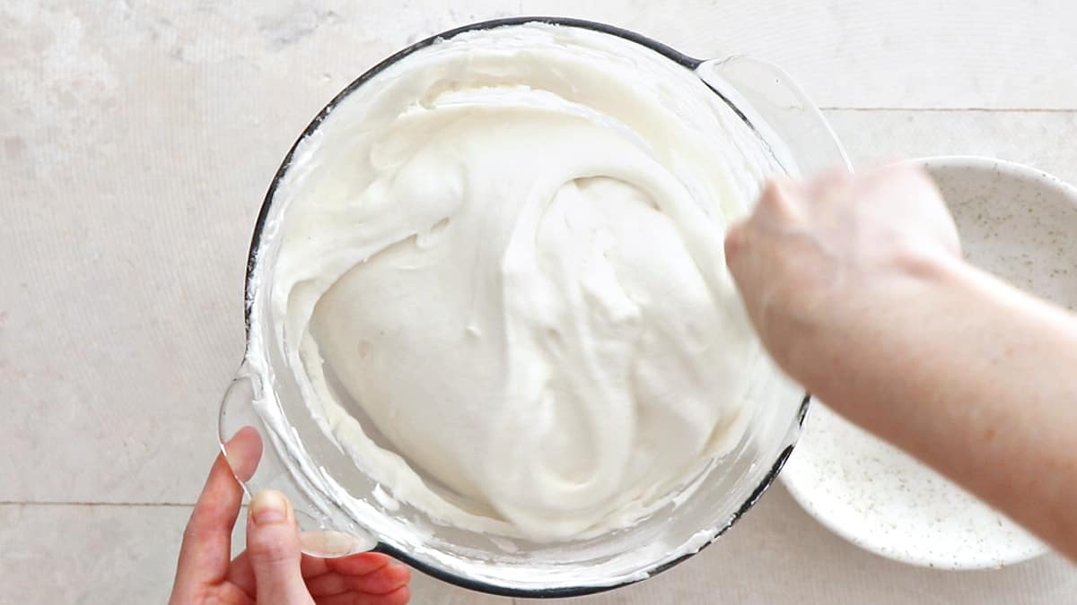 Folding flour and sugar into the mixed egg whites