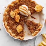 Decorative picture of baked apple crumble pie on bright background