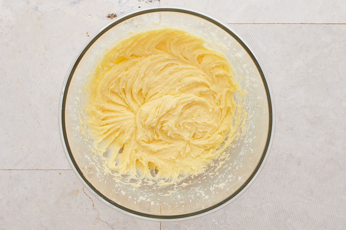 Butter, sugar, and eggs mixed in a mixing bowl