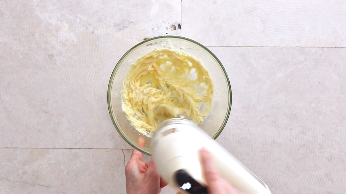 Mixing butter in a mixing bowl with an electric mixer