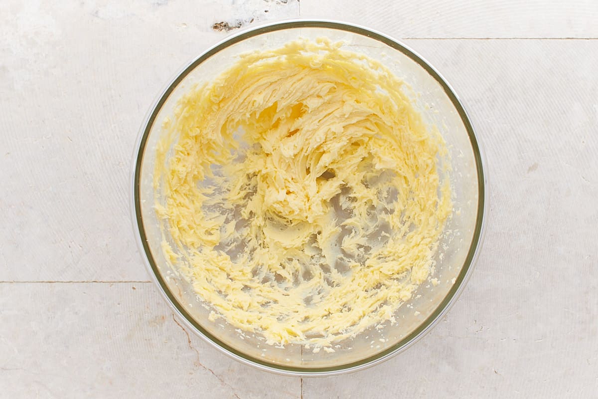 Butter and sugar mixed in a large mixing bowl