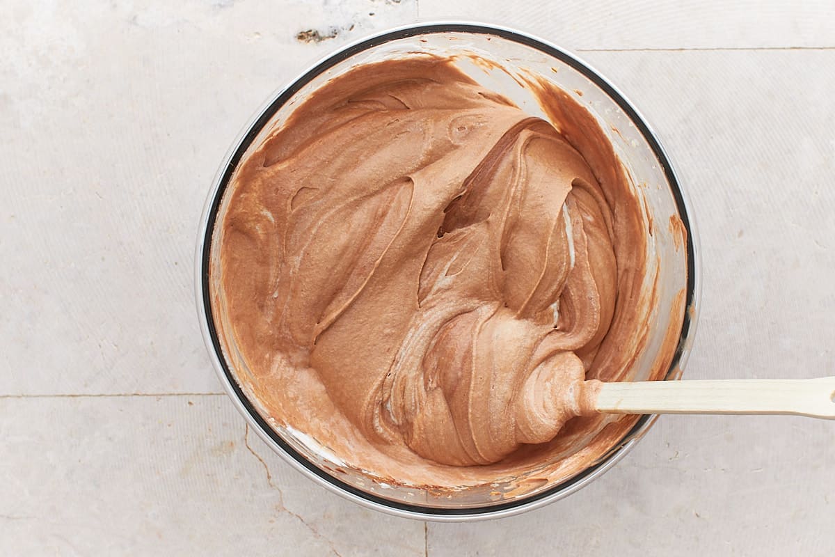 Folded chocolate batter in a mixing bowl
