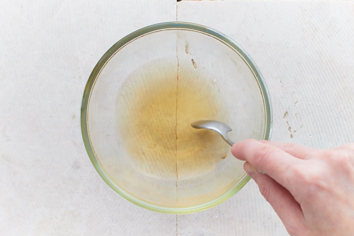 Stiring rice vinegar, sugar, and salt in a small bowl