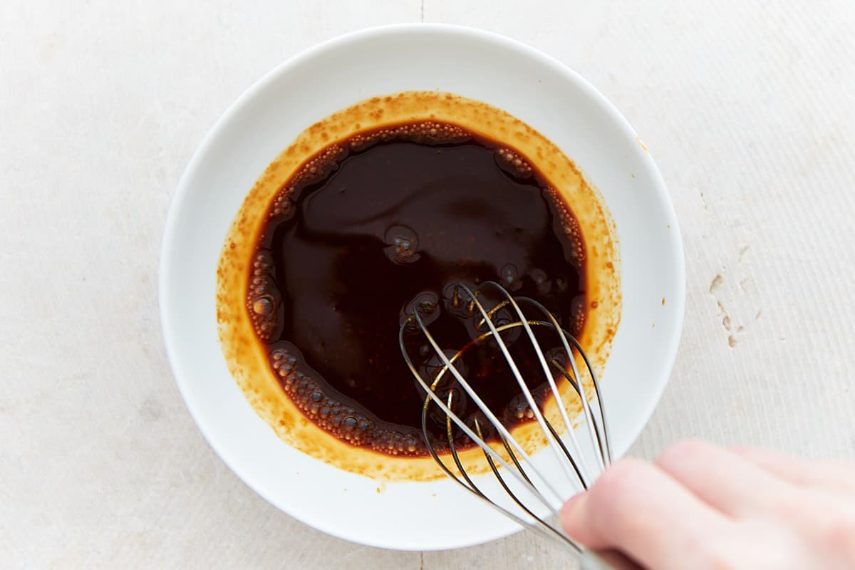Whisking sushi sauce containing of soy sauce and wasabi