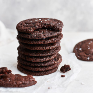Stack of chocolate cookies on bright background