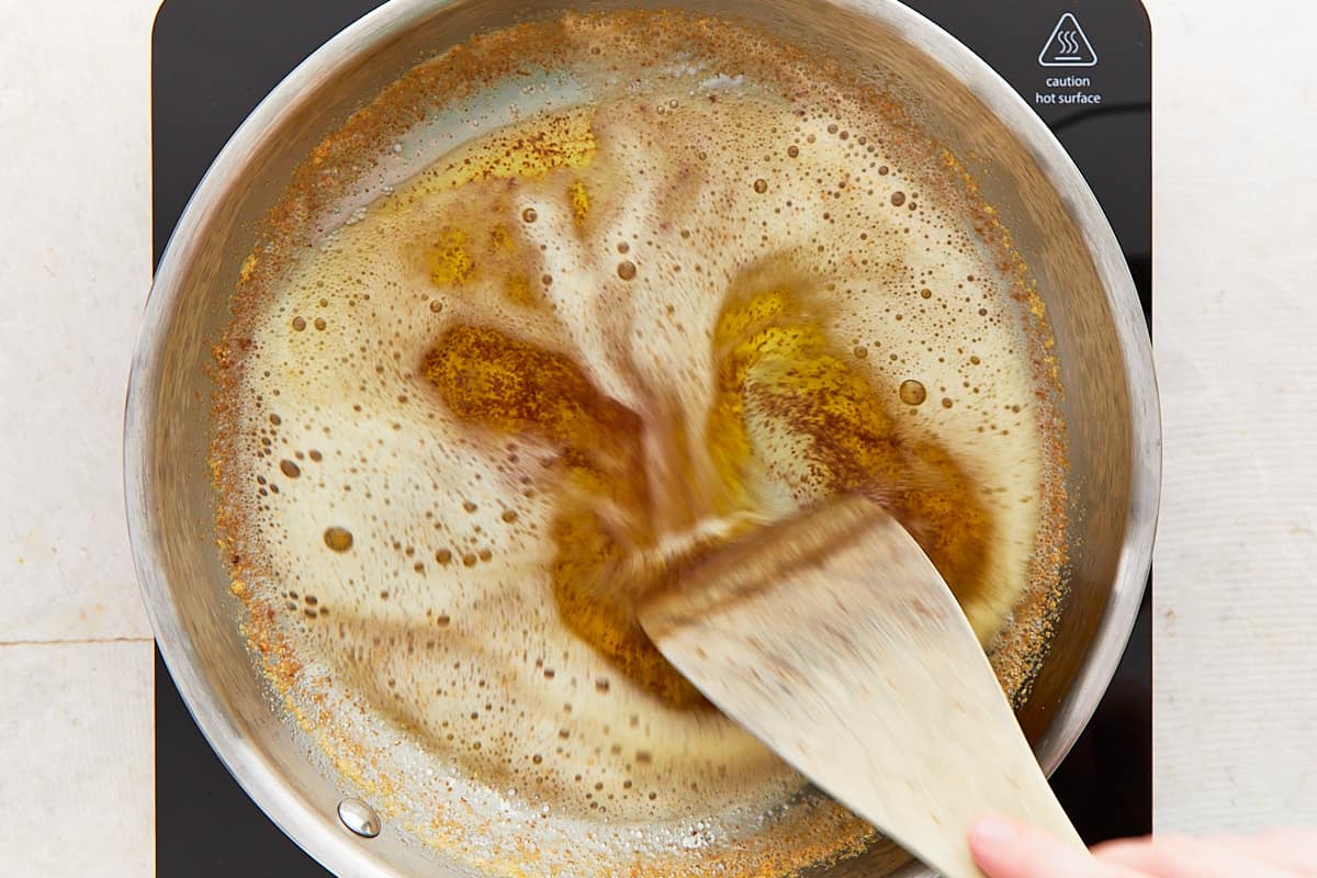 Stirring browned butter in a pan