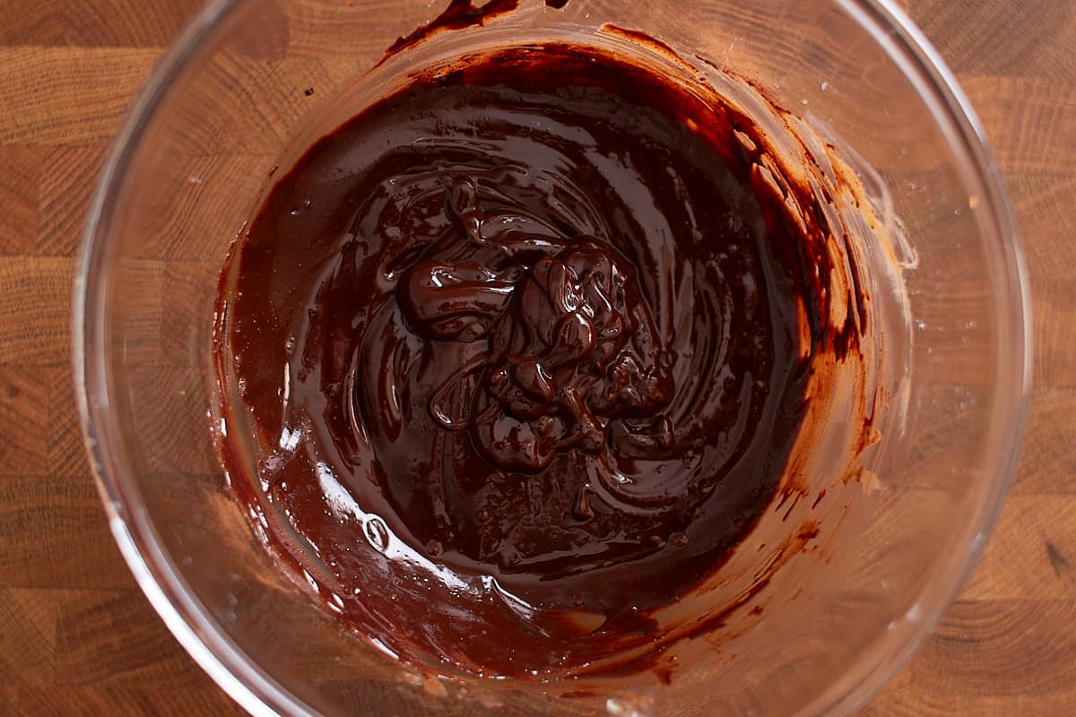 Chocolate, butter, cocoa, and espresso powder, whisked in a glass bowl