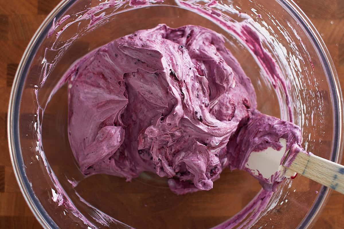 Blueberry sauce and cream cheese mixed together in a bowl