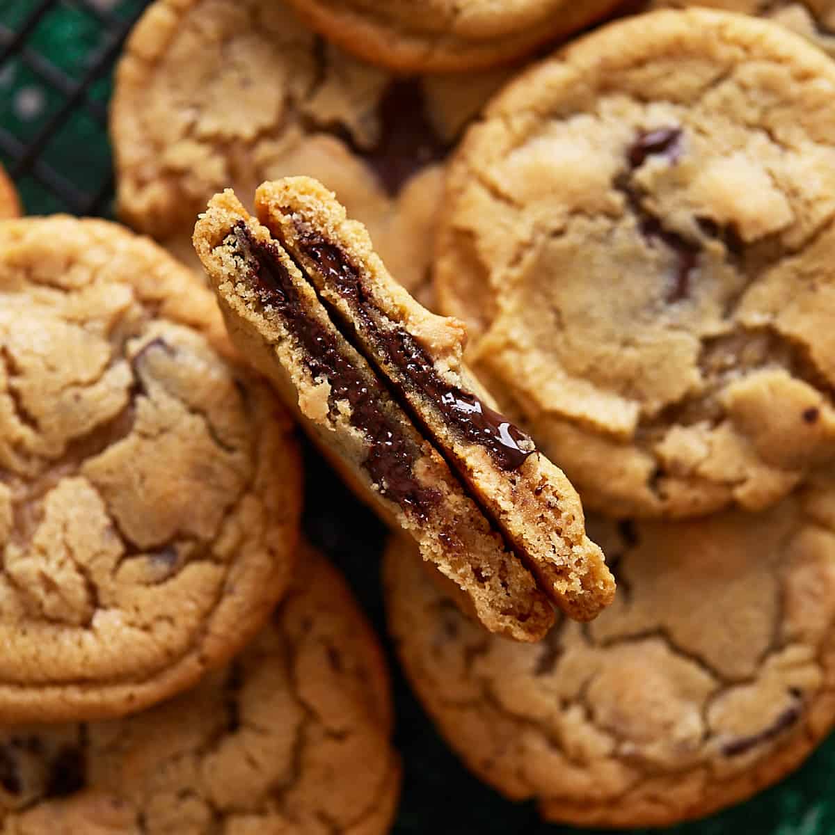 A cookie broken in half surrounded by other cookies