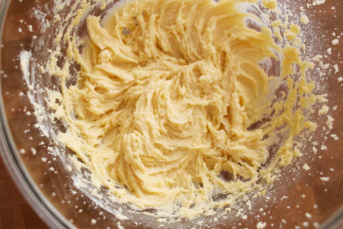 Butter, sugars, egg, and vanilla mixed together in a bowl